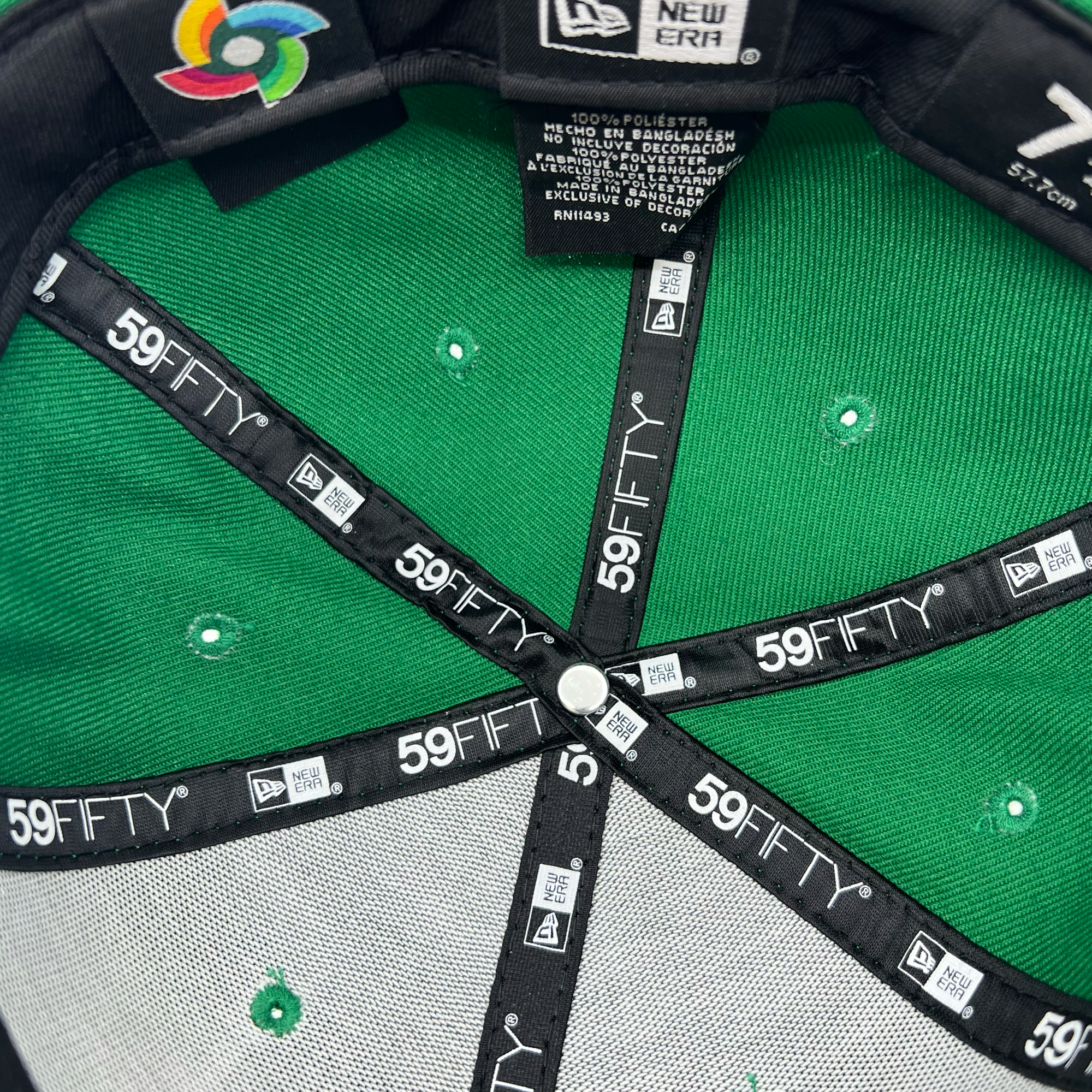 Inside crown of a green fitted New Era cap with black 59FIFTY  taping on repeat.