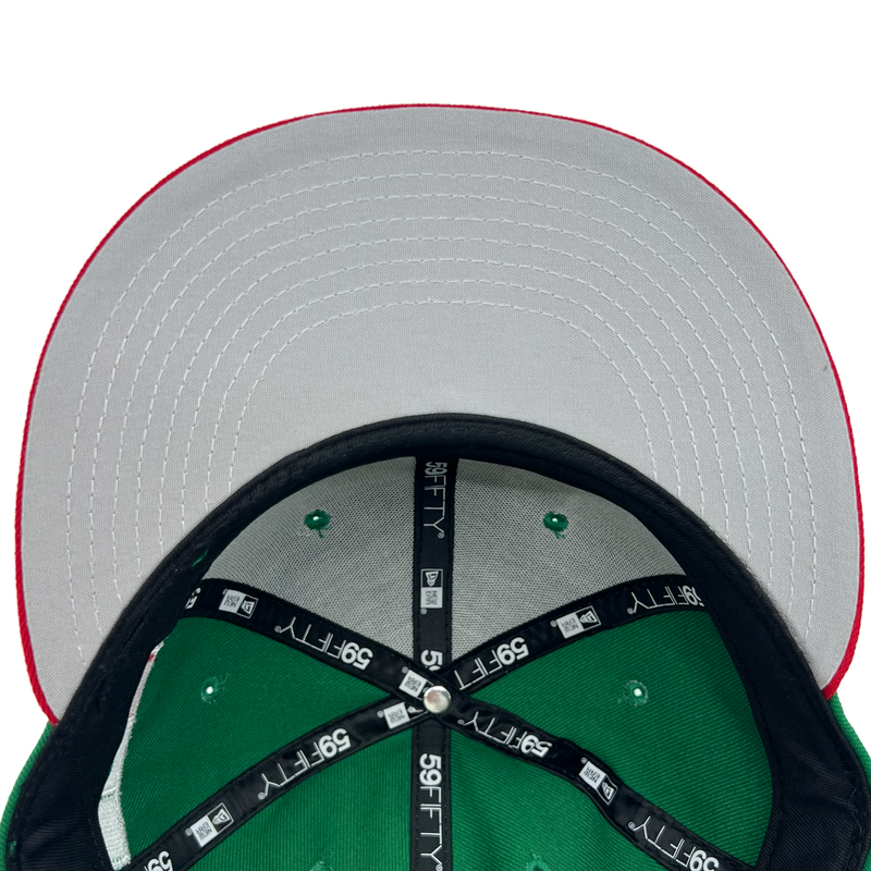 Gray undervisor and view inside crown of a green fitted New Era cap with  59FIFTY taping on repeat.
