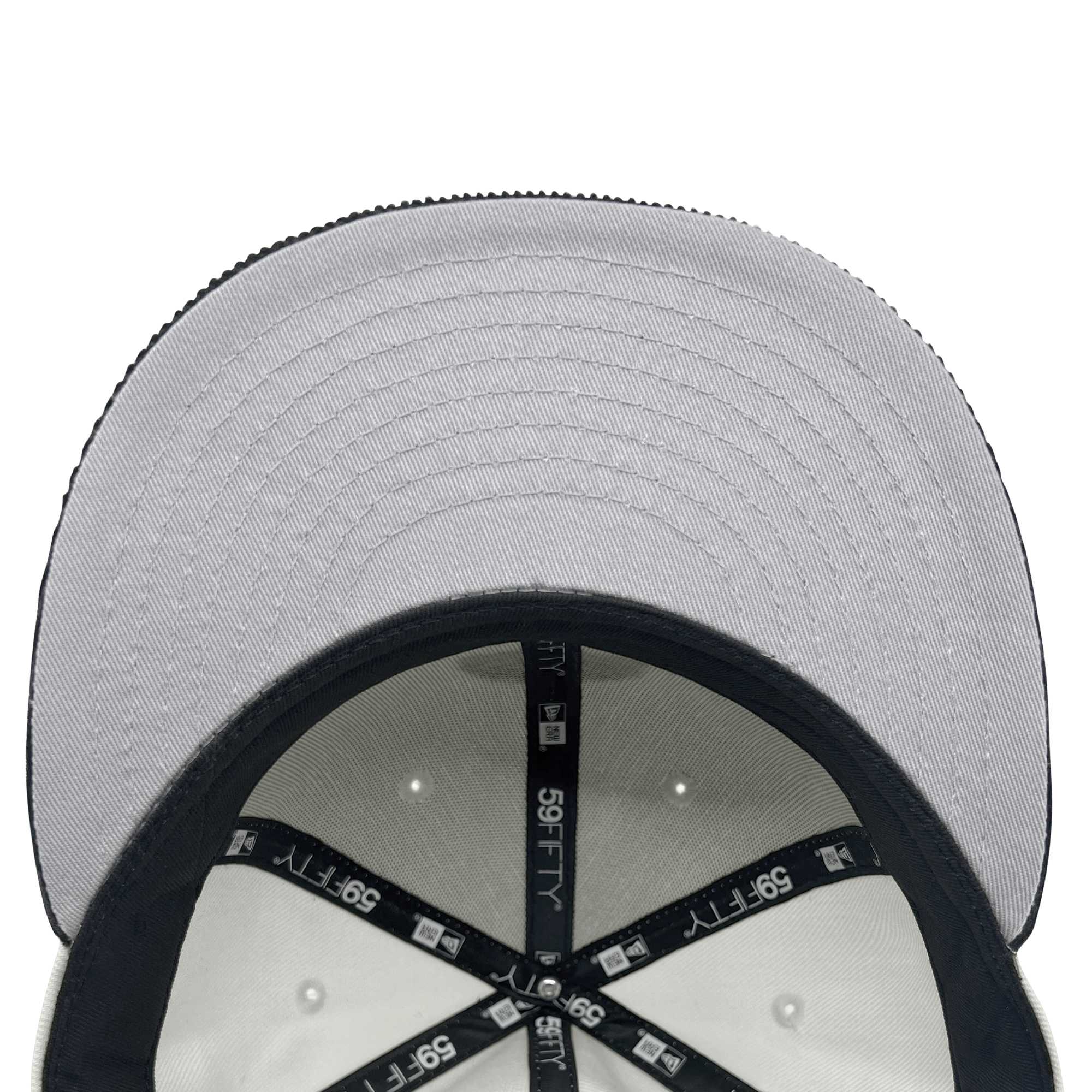 Close-up inside crown view of New Era 59FIFTY chrome white fitted cap with black New Era wordmark on repeat on taping and grey under visor.