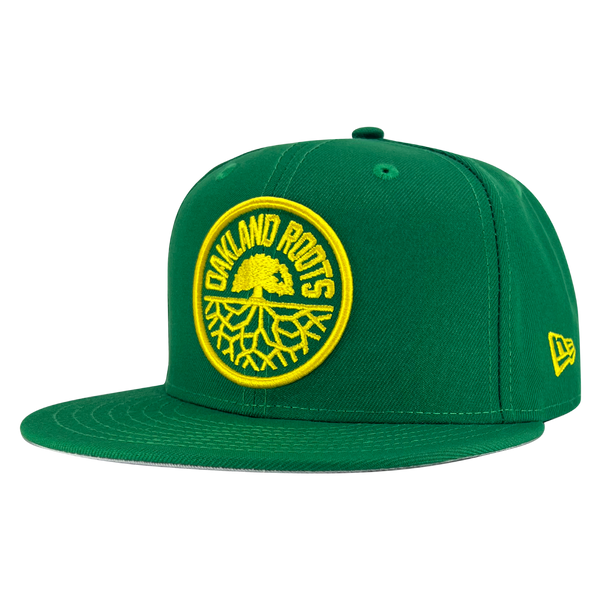 New Era 59FIFTY kelly green snapback hat with a yellow embroidered Oakland Roots SC crest - angled to show the New Era logo on the left wear side.