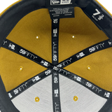 Close-up inside crown view of New Era 9FIFTY gold fitted cap with black New Era wordmark on repeat on taping.