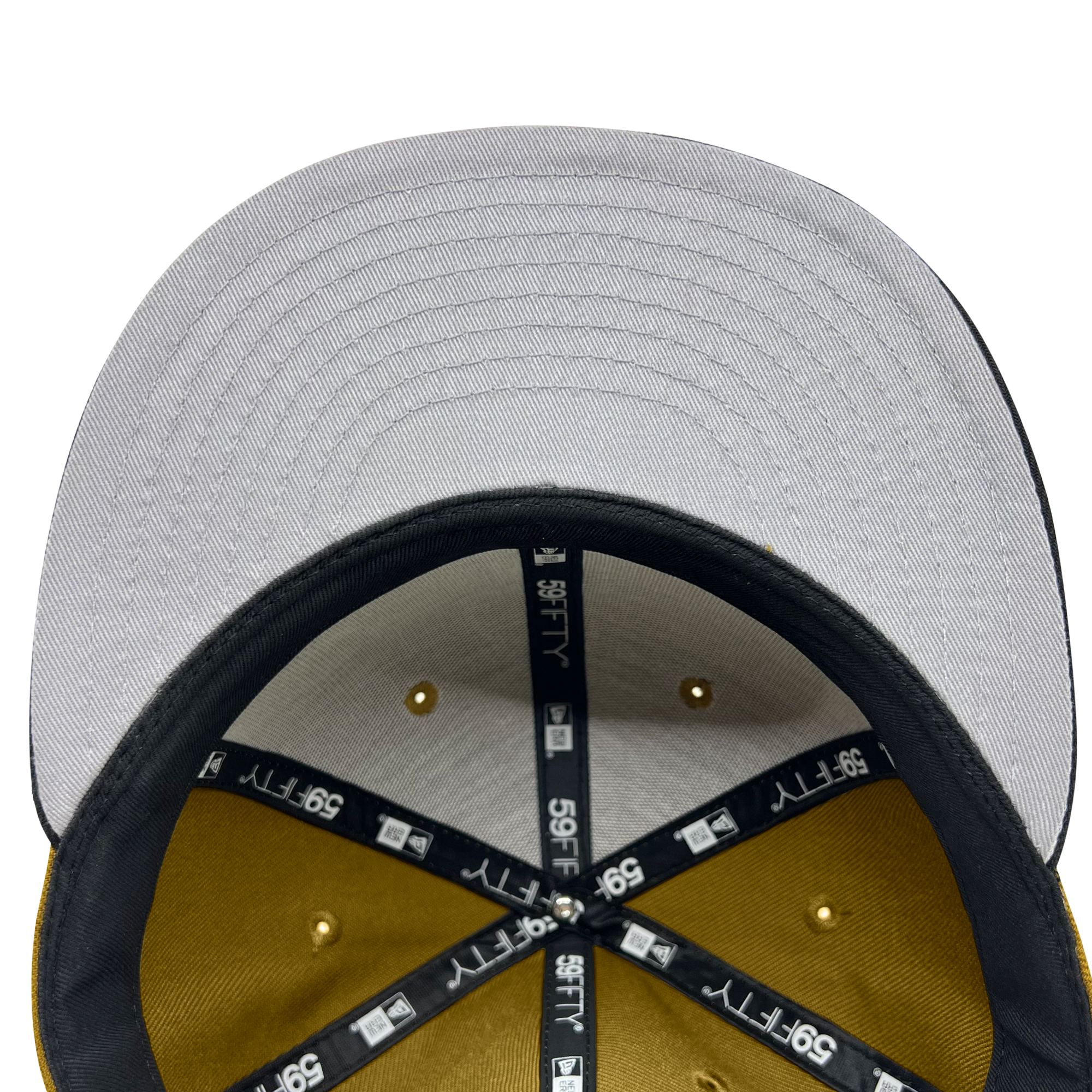 A close-up view of the underside of a gray New Era Official 59FIFTY Fitted Cap by Oaklandish. The inside taping features the New Era logo and "59FIFTY" text in white. The interior panels are lined with mustard-yellow fabric, and the cap includes a black sweatband. This design perfectly captures that Oaklandish vibe.
