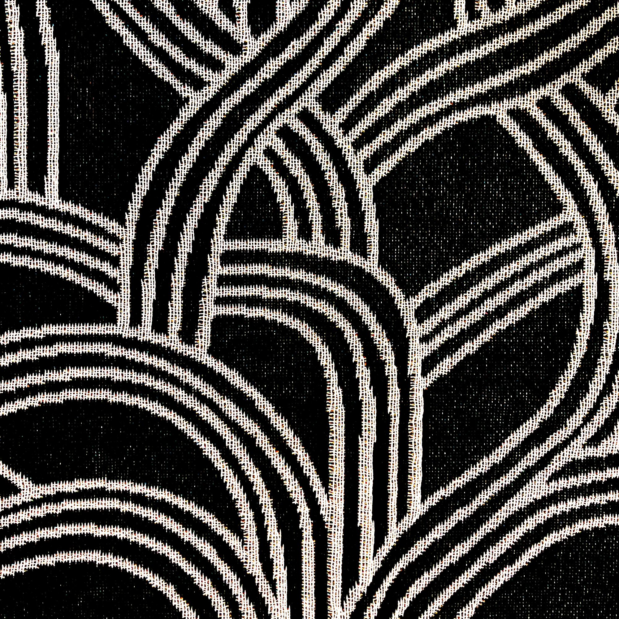 Detailed close-up of pattern inside the Oaklandish tree logo on a black throw blanket.