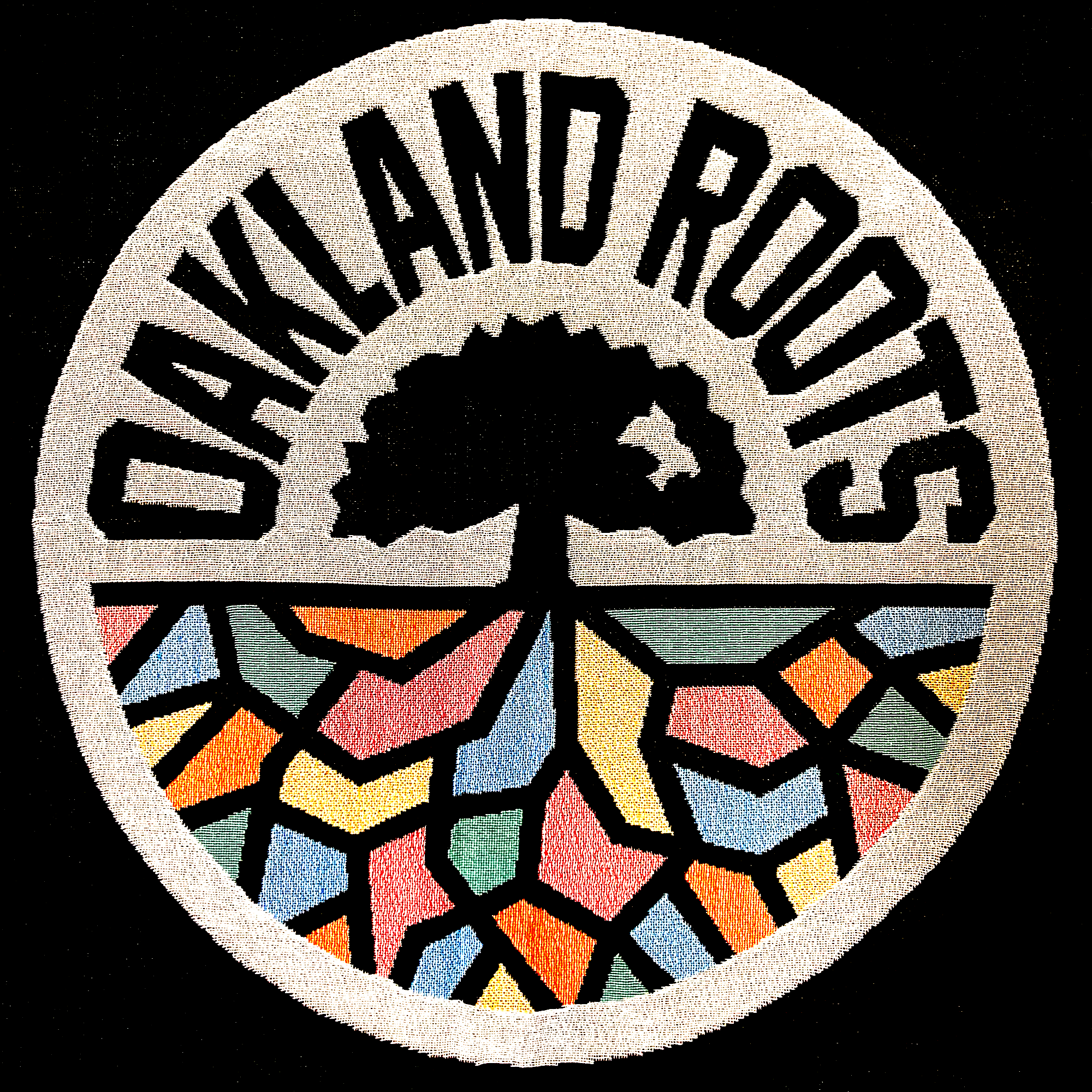 Detailed close-up of large full-color Oakland Roots SC circle logo on a black blanket.