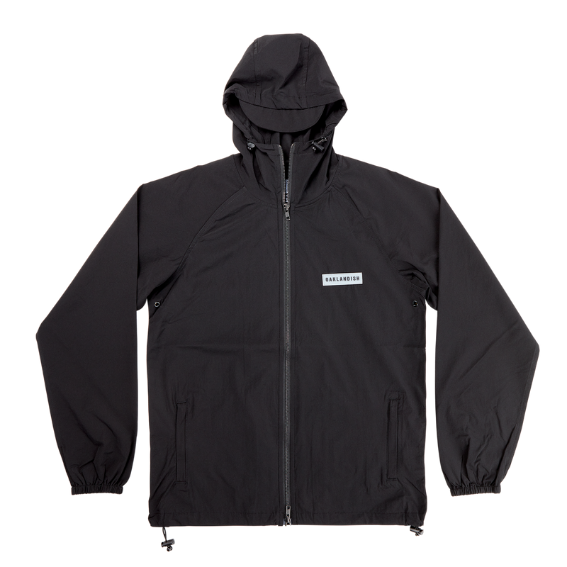Black lightweight zip up hooded jacket with OAKLANDISH wordmark patch on the chest.