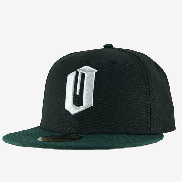 New Era 9FIFTY black cap with white embroidered O for Oakland & green bill. Tilted to show New Era logo on left wear side.