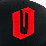 Close up of red embroidered O for Oakland on black New Era cap.