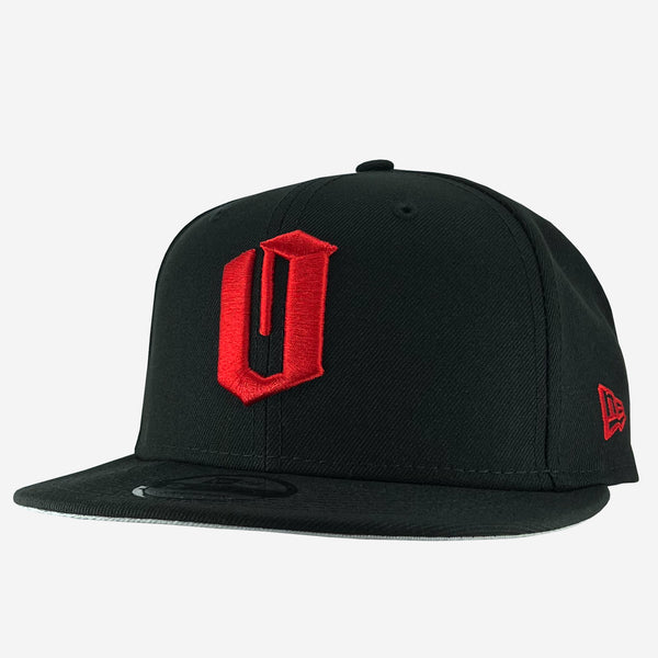 New Era 9FIFTY black cap with red embroidered O. Tilted to see red embroidered New Era logo on left wear side. 
