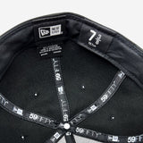 View of inside the crown of New Era 9FIFTY black cap with black New Era striping.