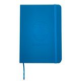 Top view of blue Oaklandish journal notebook elastic closure and bookmark with Oakalndish tree logo and wordmark embossed on the cover. 