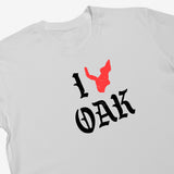Close-up of a white women's t-shirt with ”I Oak” in black font and a red map of Oakland replacing the heart between I and Oak.