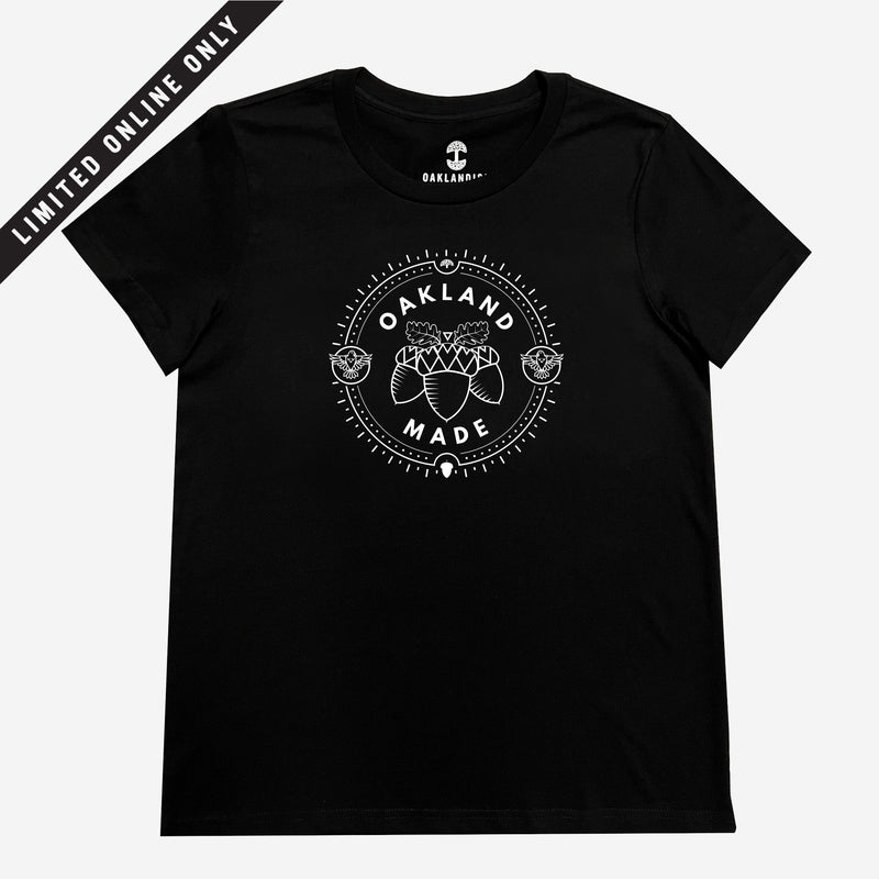 Women’s black t-shirt with white hand-drawn Oakland Made wordmark and chesnuts in a circular graphic on chest.
