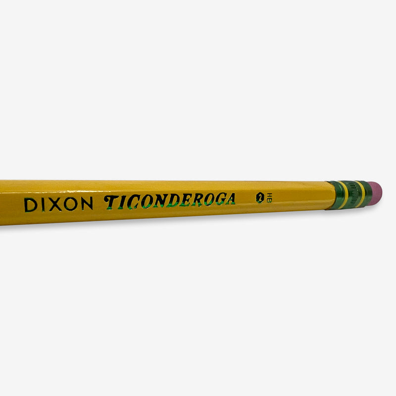 Close up of Ticonderoga No. 2 wordmark on the side of yellow Ticonderoga No. 2 hex pencil with three green stripes under the pink eraser.