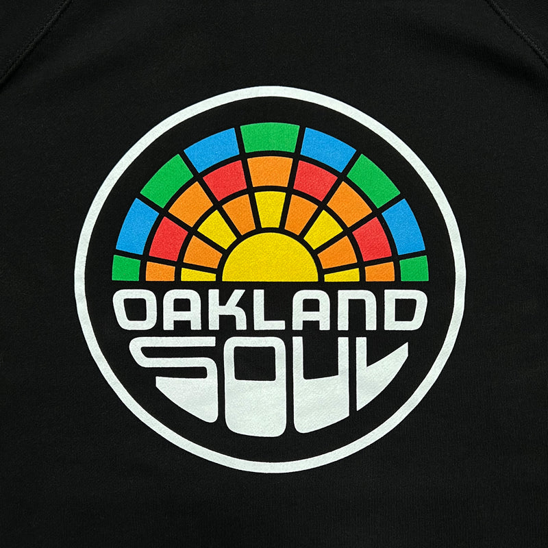 Close up of full color Oakland Soul logo on a black zip hoodie.