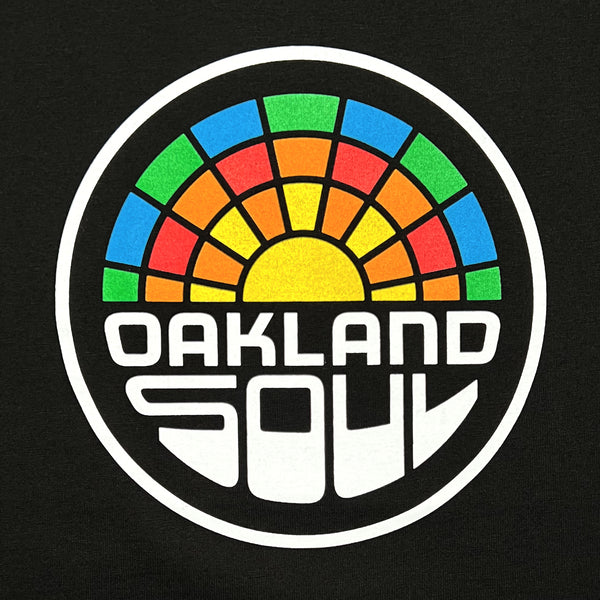Close up of a full color Oakland Soul logo on black t-shirt.