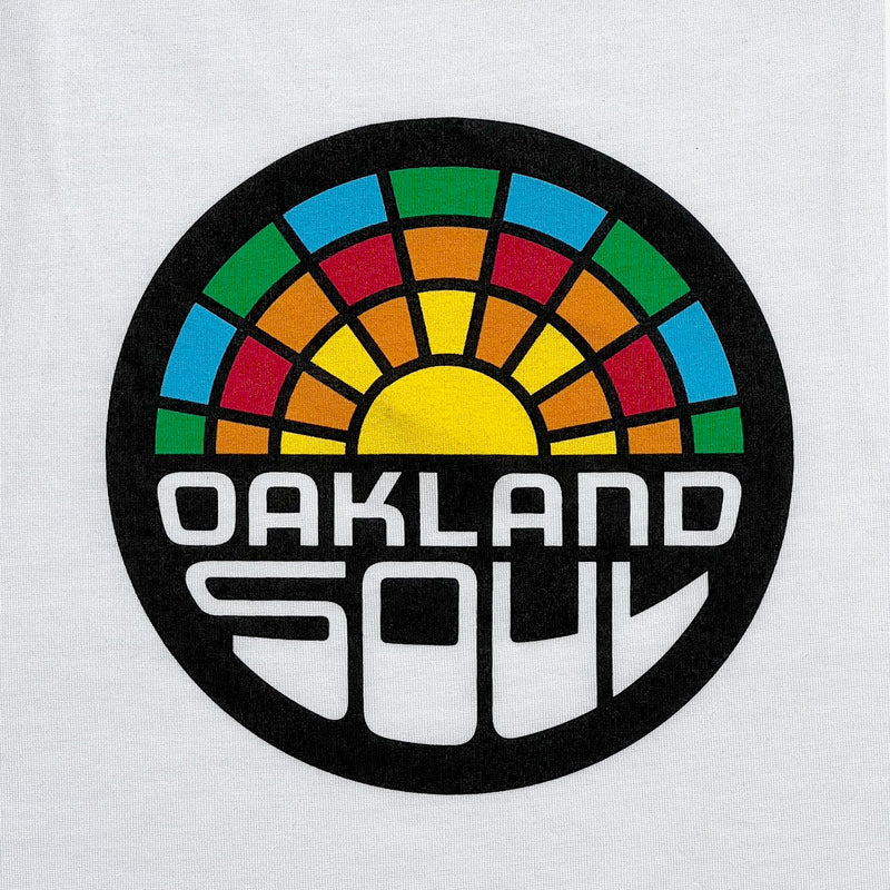 Close up of a full-color Oakland Soul logo on the front of a white tank top.