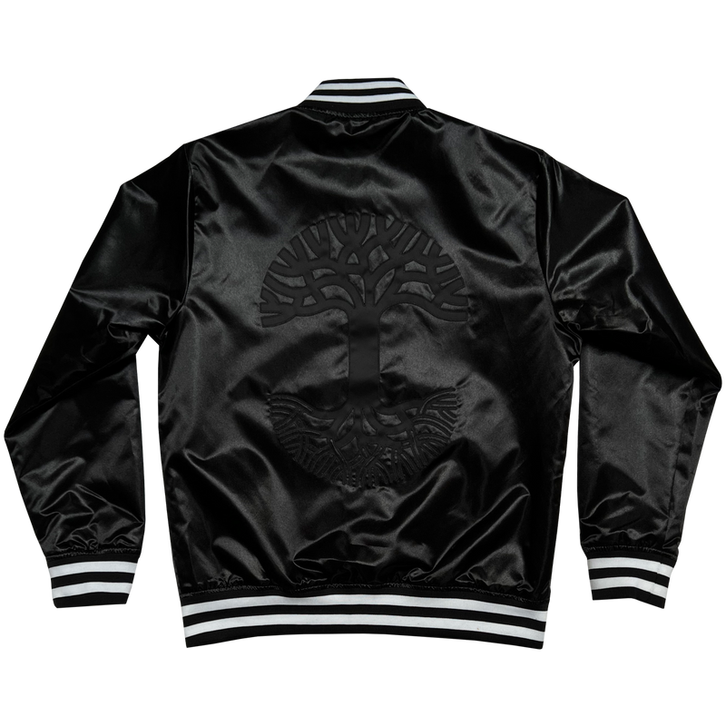  The backside of Mitchell & Ness black satin reversible jacket with a large centered Oaklandish tree logo with black and white ribbing at the collar, cuff, and waistband.