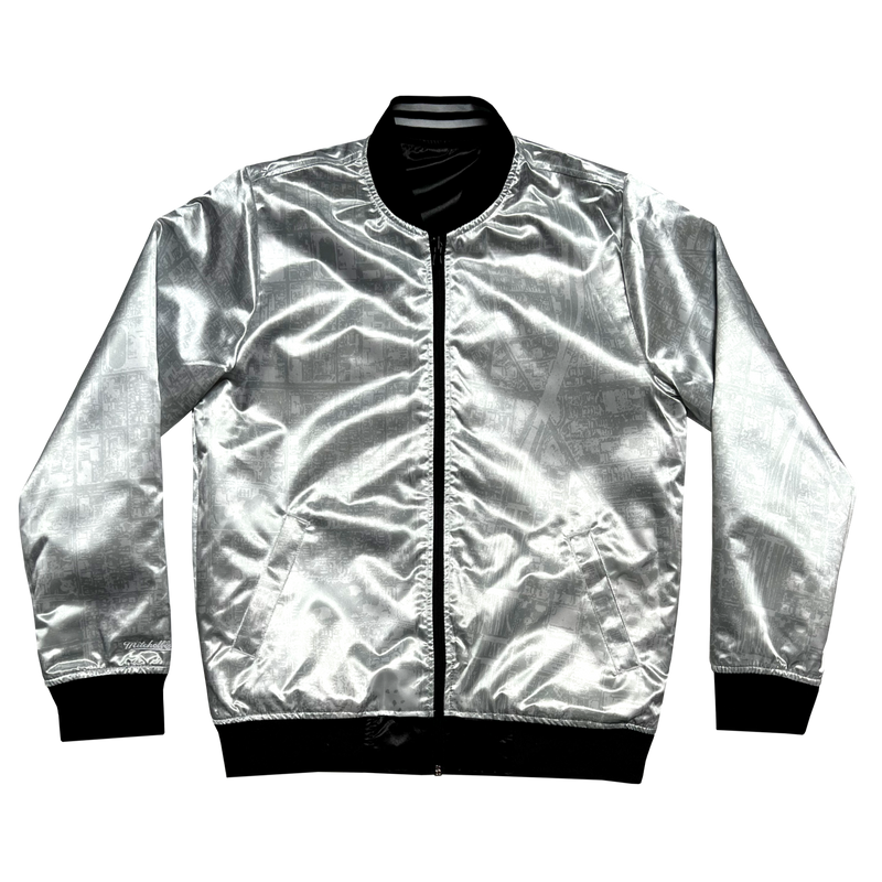 Front view of the silver reverse side of a satin jacket, imprinted with an aerial map of Oakland.
