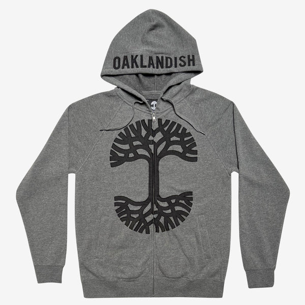 Grey zip-up hoodie with pigment black Oaklandish tree appliqué on the chest and charcoal Oaklandish wordmark on the hood.