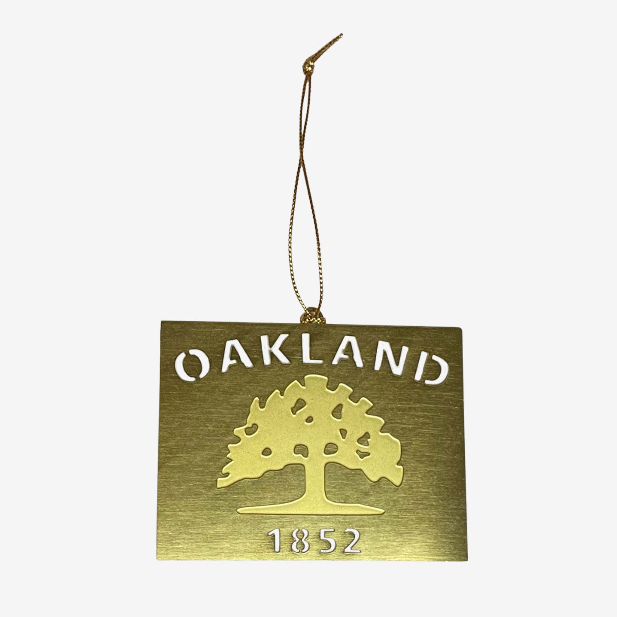 An Oakland flag is depicted in cut-out brass on a string for a holiday tree.