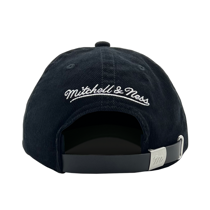 Back view of a black snapback dad cap with white embroidered Mitchell & Ness wordmark. 