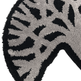 Detailed close-up of section of the Oaklandish tree logo on black and light grey area rug.