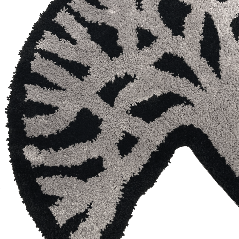 Detailed close-up of section of the Oaklandish tree logo on black and light grey area rug.