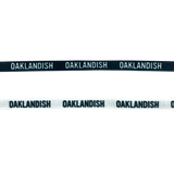 Two shoelaces one white and one black with OAKLANDISH wordmark on repeat.