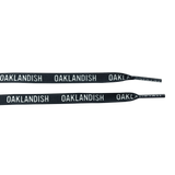 Ends of two black shoelaces with white OAKLANDISH wordmark on repeat.