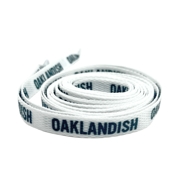 Rolled white shoelace with black Oaklandish wordmark on repeat.