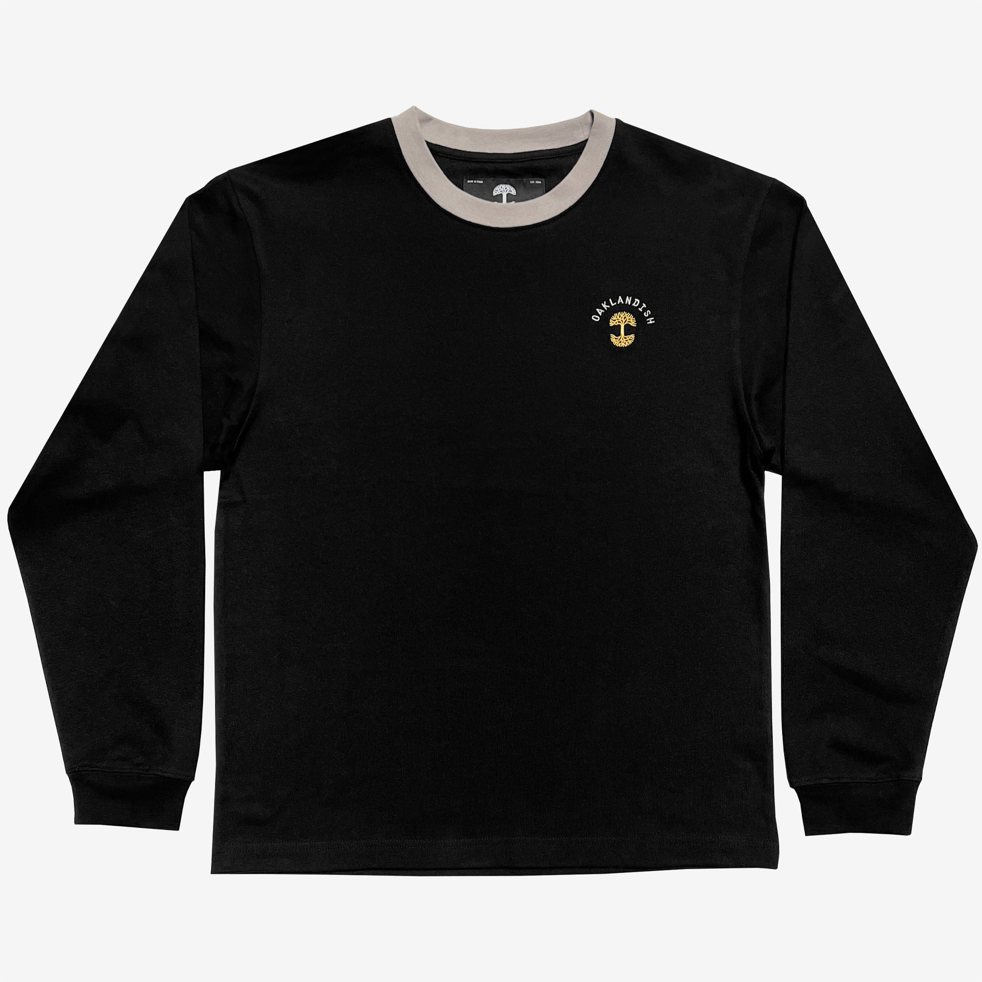 Black long sleeve crew neck tee with a gold Oaklandish tree logo, white wordmark on the left chest, and grey trim on neck.