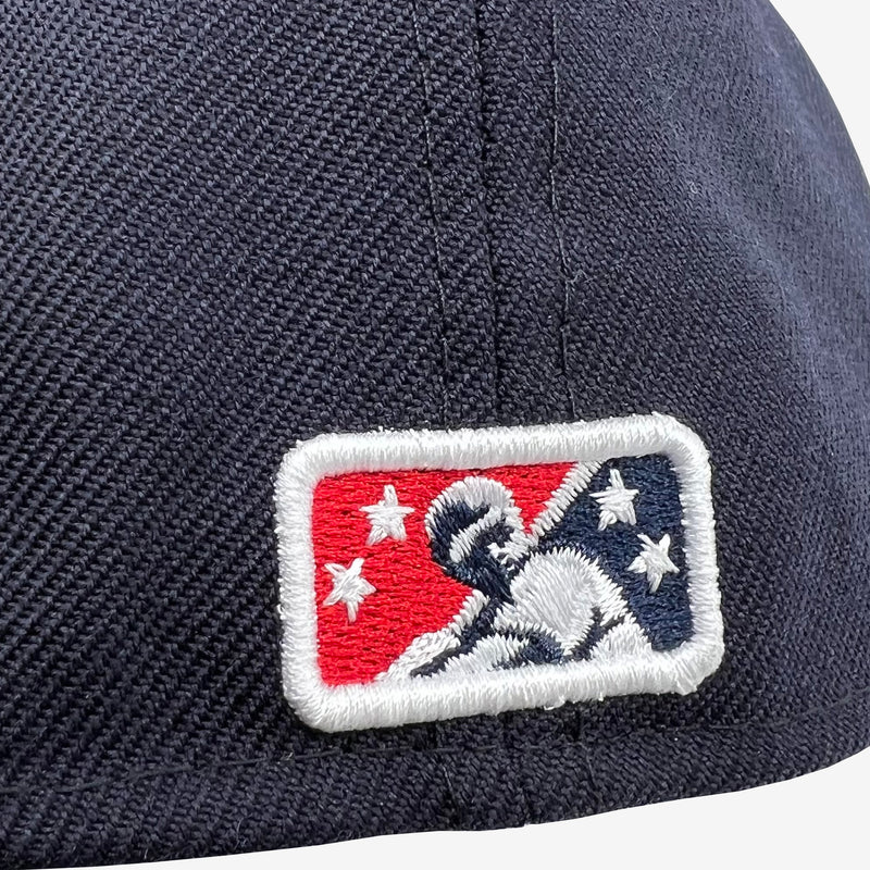 Close-up of Minor League Baseball logo on the backside of a navy fitted cap.