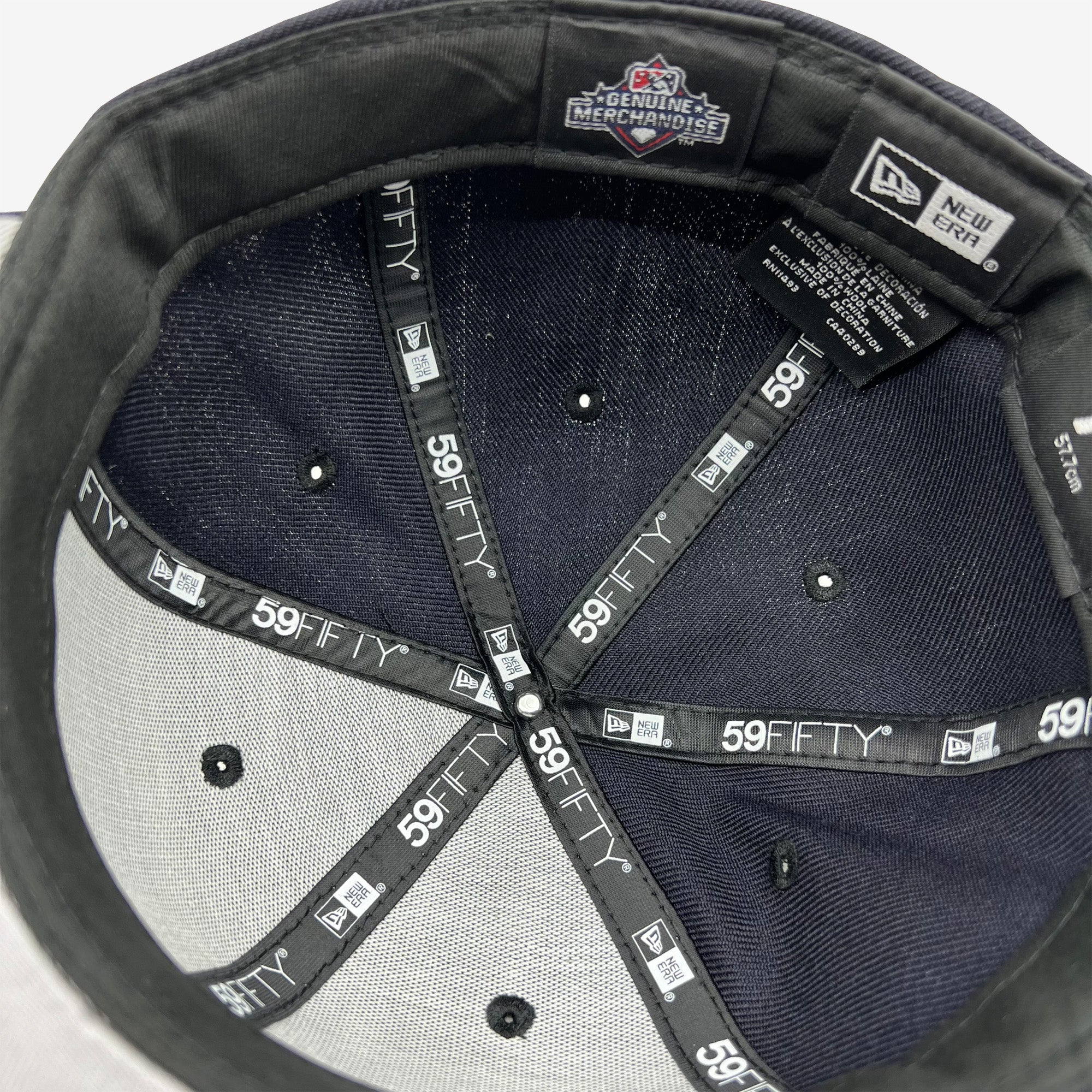 The inside of the crown of a fitted New Era cap with black taping with 59FIFTY New Era wordmark on repeat. 