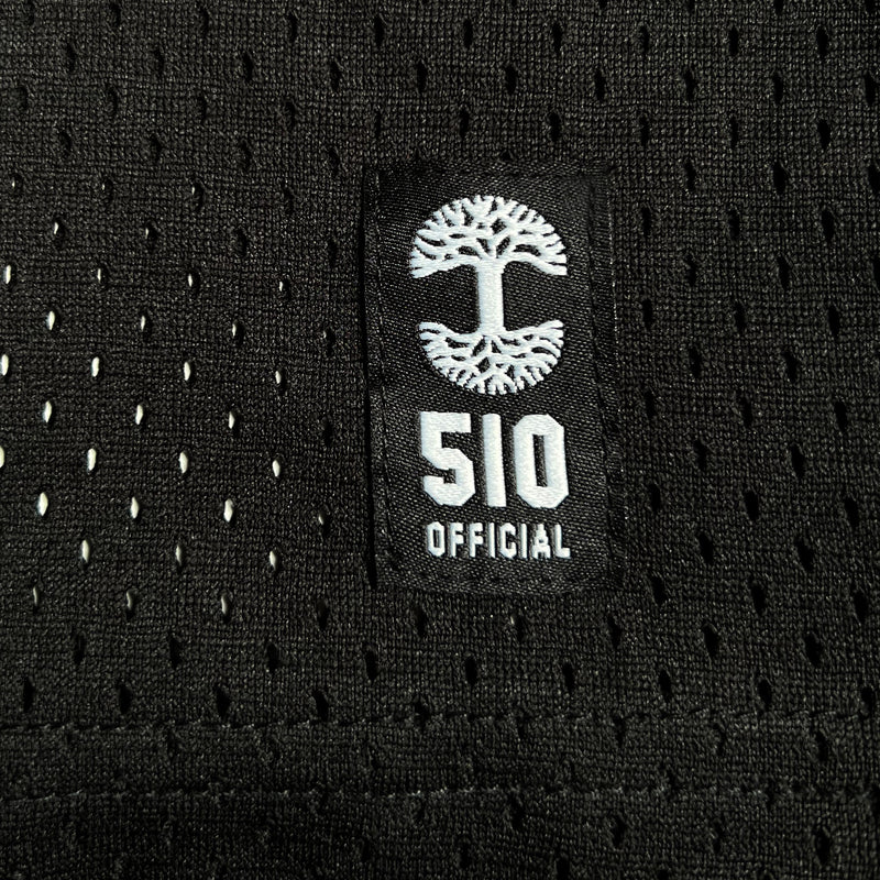 Black patch with white Oaklandish tree logo and wordmark on a black mesh football jersey.