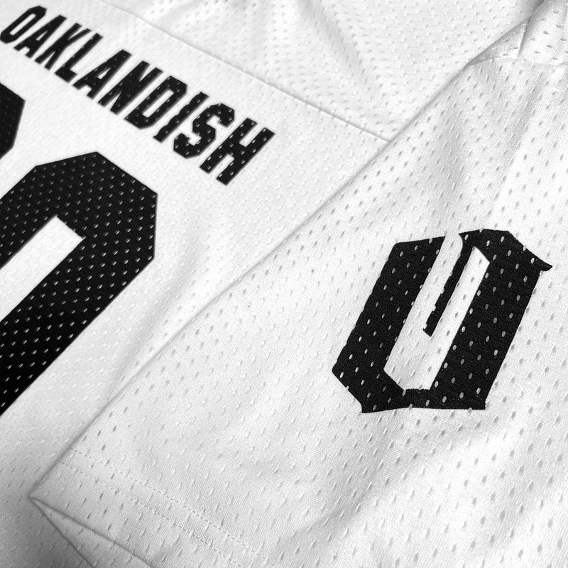Black O for Oakland on sleeve of a white mesh football jersey.