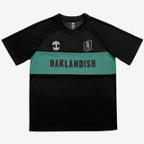 Black soccer jersey with a green stripe with black OAKLANDISH wordmark and white Oaklandish tree logo, and O appliques.