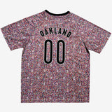 The backside of a multi-colored speckled soccer jersey with OAKLAND 00 applique.
