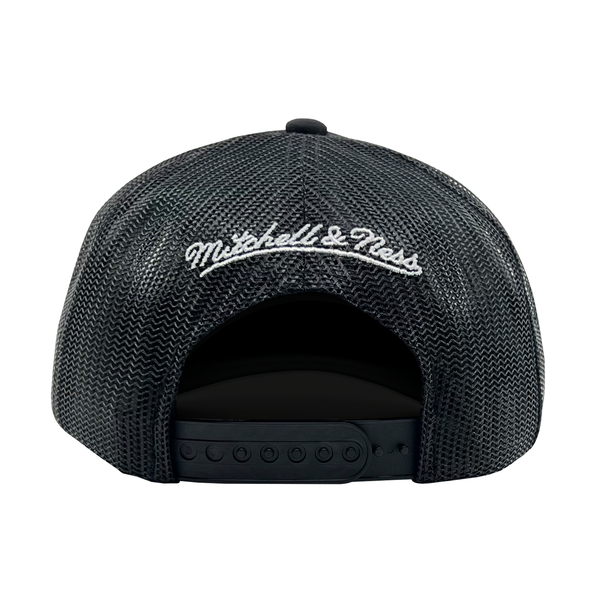 The image showcases the back of an Official O Trucker hat by Oaklandish, featuring "Mitchell & Ness" embroidered in white cursive lettering on the adjustable black mesh closure. The hat sports a curved opening for the head and snap buttons to ensure a perfect fit.