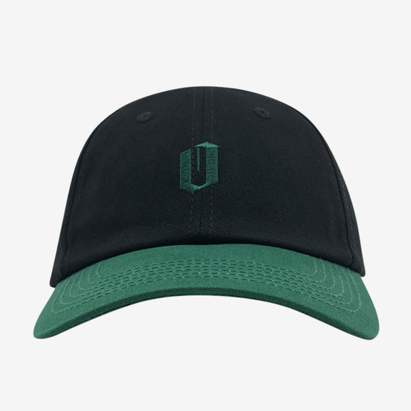 Black dad hat with forest green embroidered 'O' logo on crown and contrasting forest brim.
