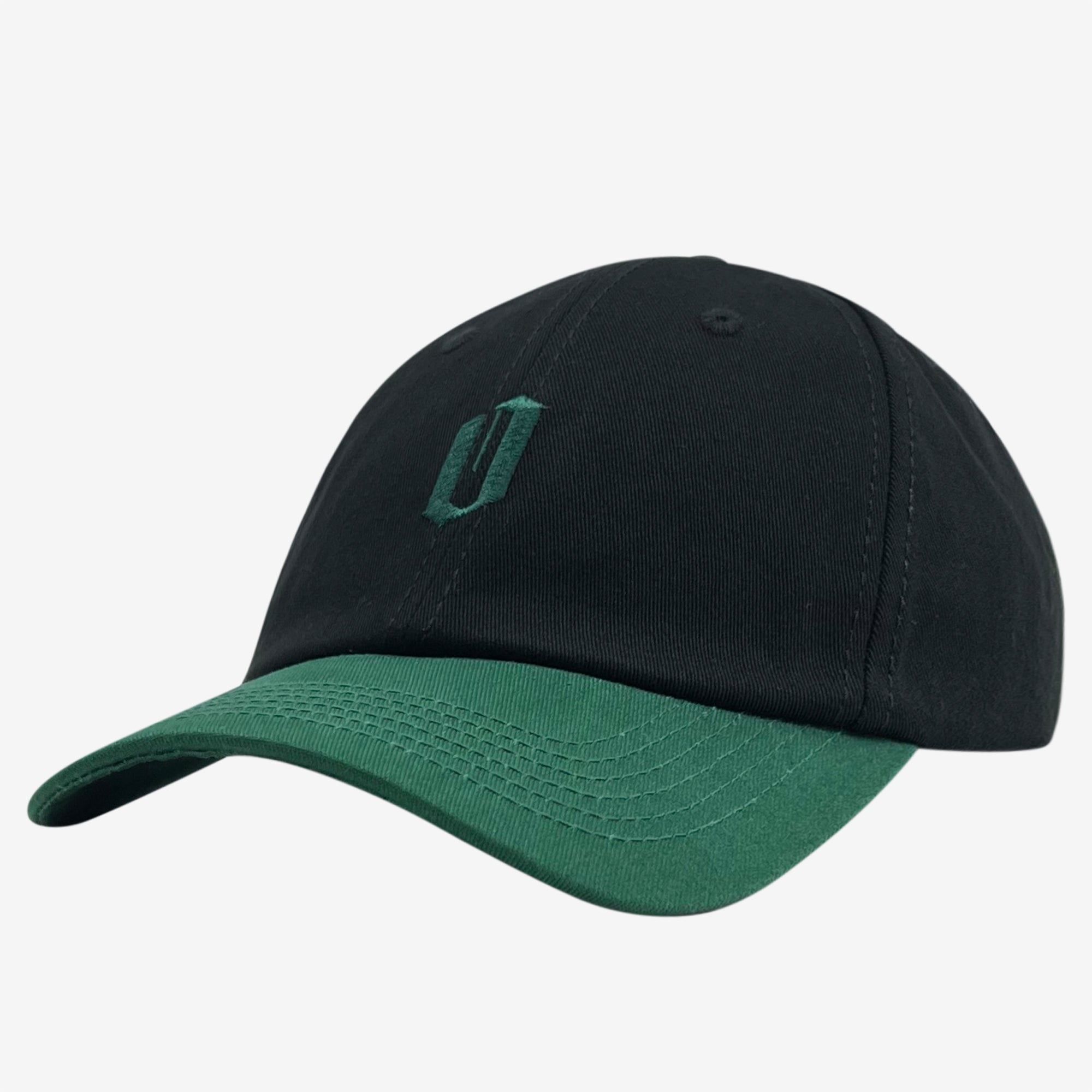 Introducing the Official Micro Logo Dad Hat by Oaklandish: a sleek black dad hat with a green visor. This cap showcases a minimalist embroidered "O" in matching green on the front, blending style with simplicity. Visible stitching on its panels and brim adds an element of detail to its overall design, making it quintessentially Oaklandish.