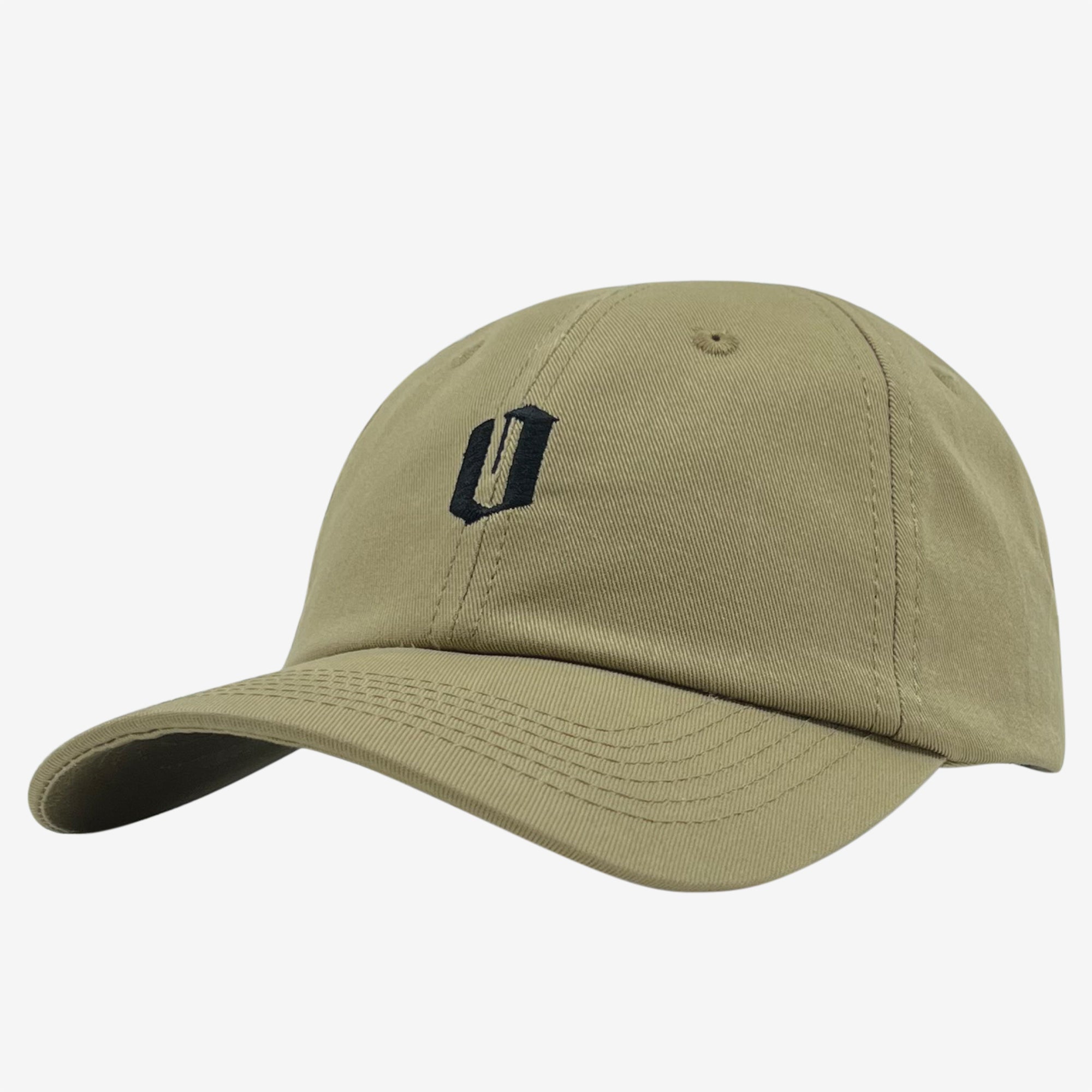 The Official Micro Logo Dad Hat from Oaklandish is a khaki green Dad hat with a curved brim, adorned with a black embroidered logo on the front. The abstract design resembles the letter "U." This cap features visible stitching, a button on top, and an adjustable strap for a perfect fit. The background is plain white.