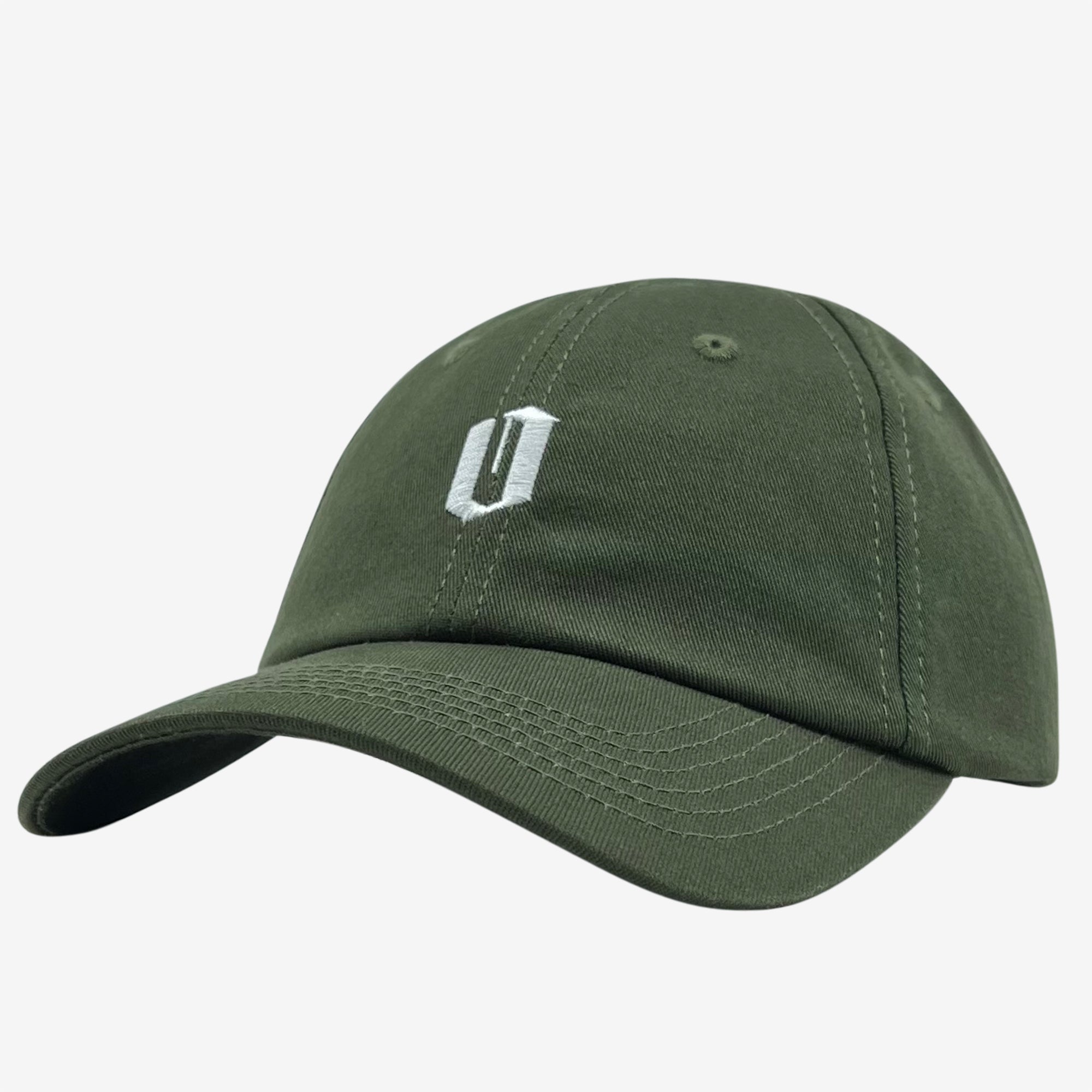 The Official Micro Logo Dad Hat by Oaklandish is a dark green Dad hat with a curved brim. The front features a white, stylized, embroidered "U" logo. The cap has six panels, each with a ventilation hole and an adjustable strap at the back. The background is white.