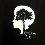 Detailed of a white OutDoor Afro logo and wordmark on a black long sleeve t-shirt.