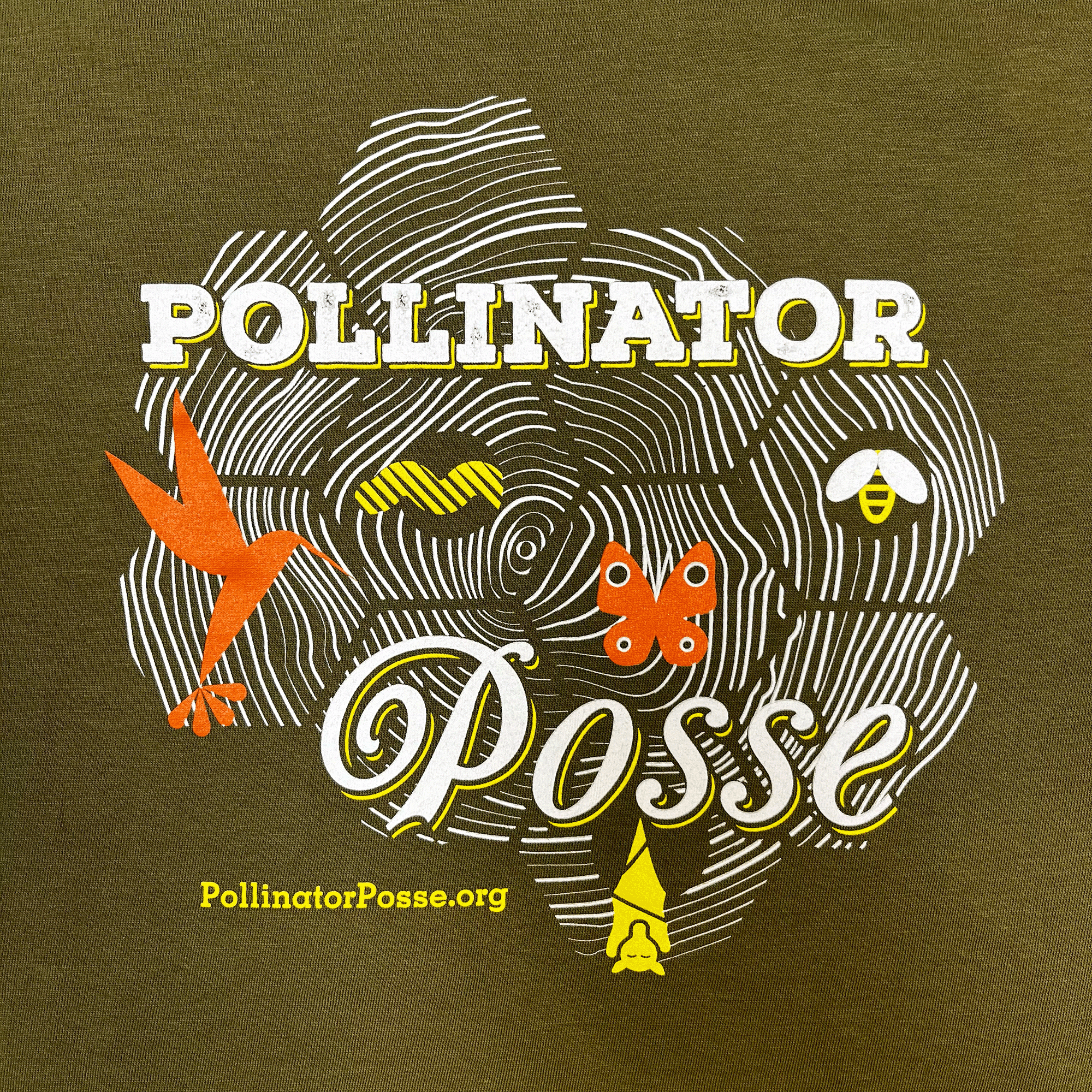Close-up on Pollinator Posse graphic on the front chest of a Loden brown t-shirt.