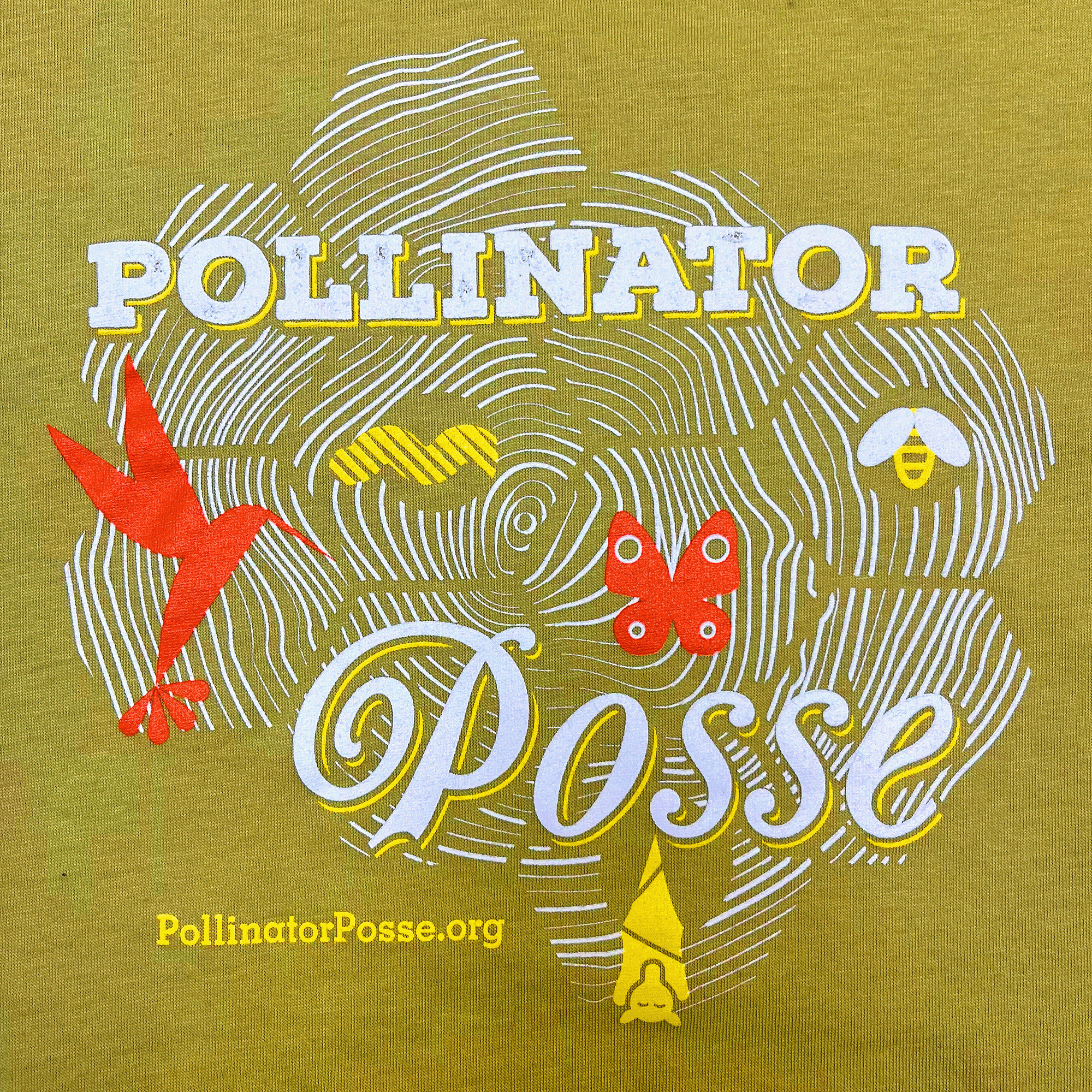 Close-up on Pollinator Posse graphic on the front chest of a Wasabi green women’s t-shirt.