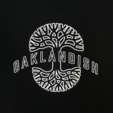 Full close up of Oaklandish wordmark on top of Oaklandish tree logo in white puff ink on black crewneck sweatshirt.
