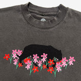 Close-up of a vintage black t-shirt with artistic bear and flower design created by artist Ant Bankxin.