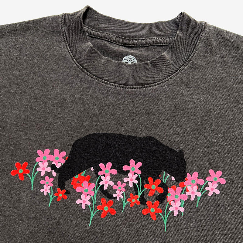Close-up of a vintage black t-shirt with artistic bear and flower design created by artist Ant Bankxin.