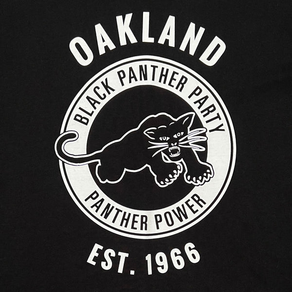 Detailed close up image of women's black t-shirt with Black Panther Party Alumni Legacy Network logo.
