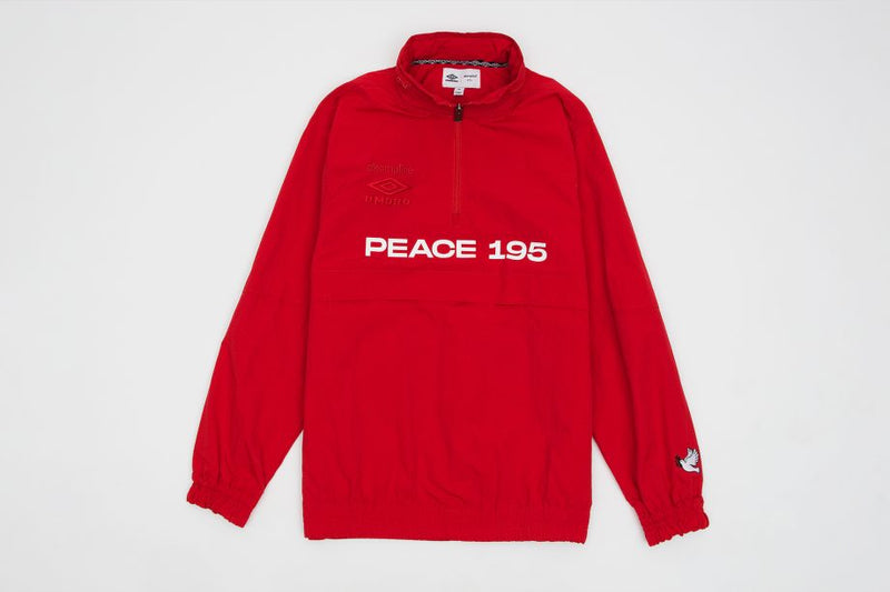 Red 1/4 zip nylon pullover hoodie detached . Embroidered umbro on front left chest and screen printed 'Peace 195' above kangaroo pocket and dove on left sleeve.